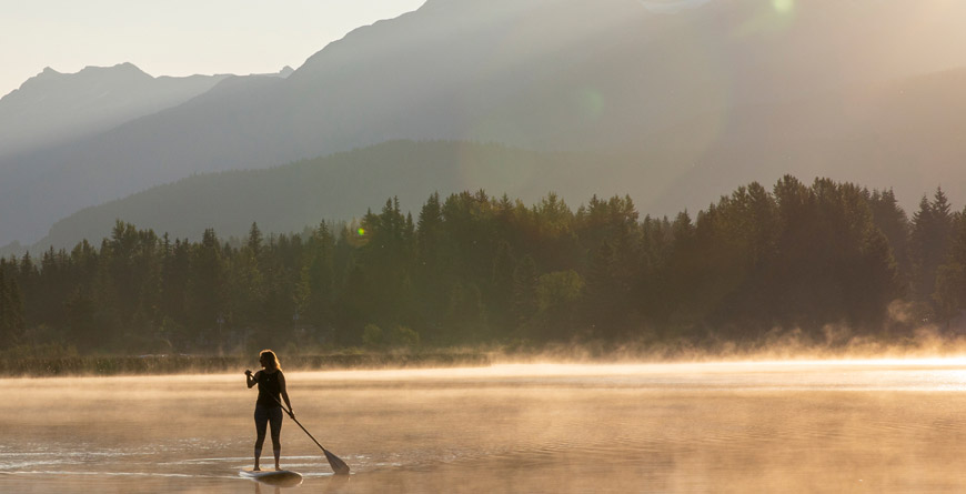 Someone paddling solo on a Whistler lake