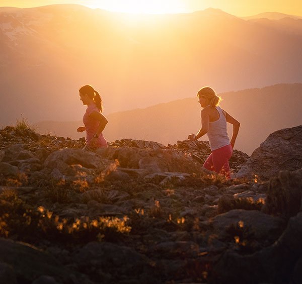 Two people trail running in the Whistler alpine