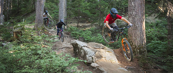 Riders in the Creekside Zone of Whistler Mountain Bike Park