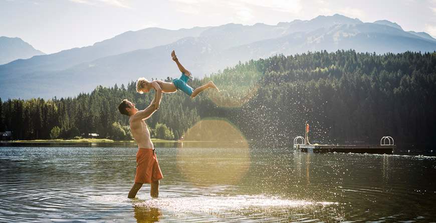 Father and son playing in the lake in Whistler BC