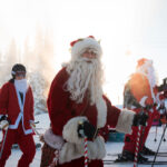 Skiers dressed at Santa ski on Whistler Blackcomb in the early morning sun.