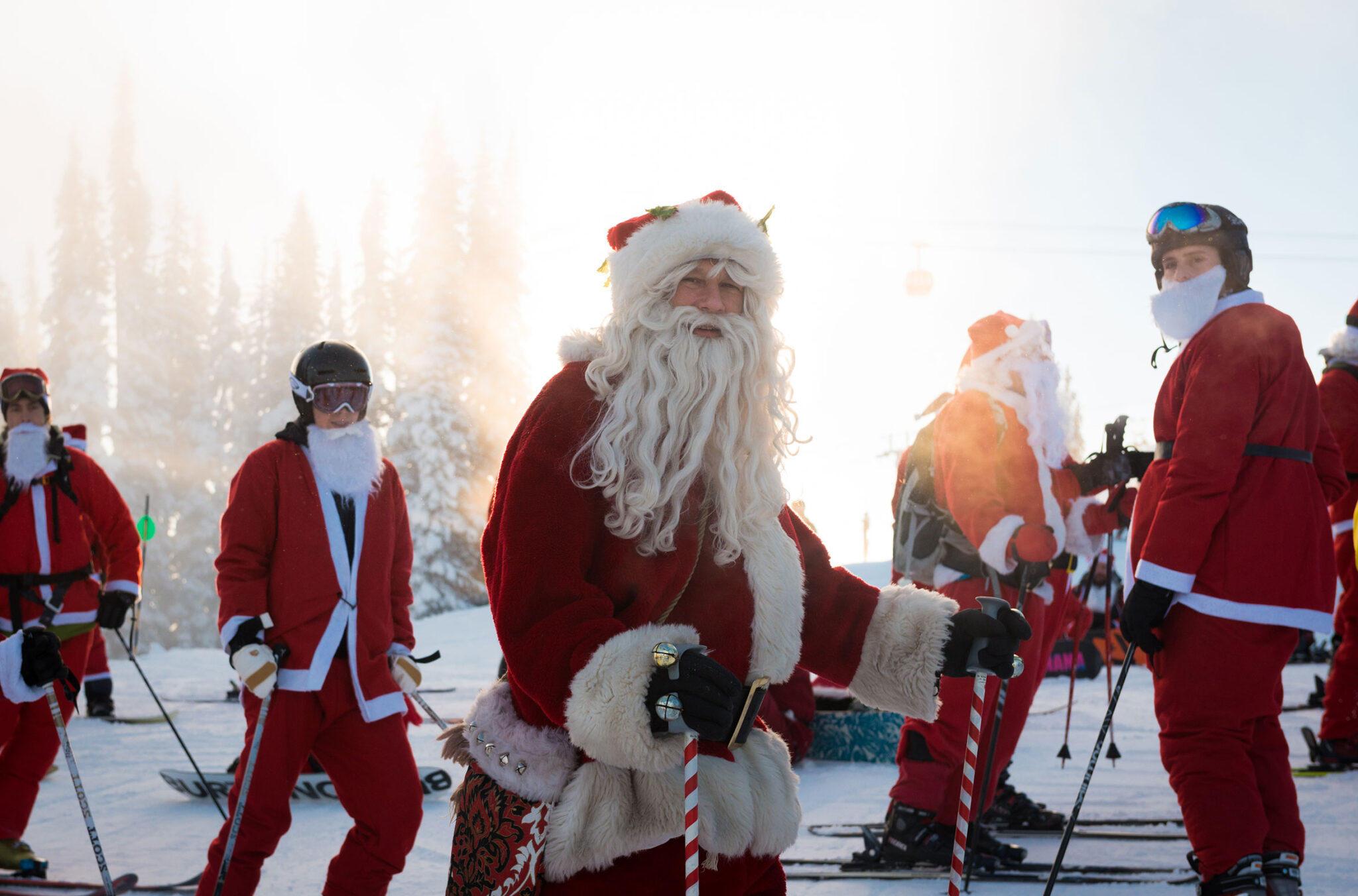 Skiers dressed at Santa ski on Whistler Blackcomb in the early morning sun.