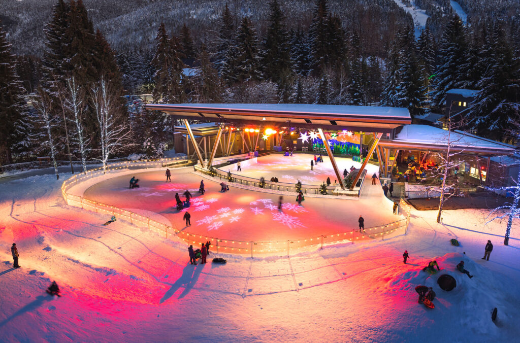 Whistler's outdoor ice skating rink at Whistler Olympic Plaza glows brightly with its festive lights.