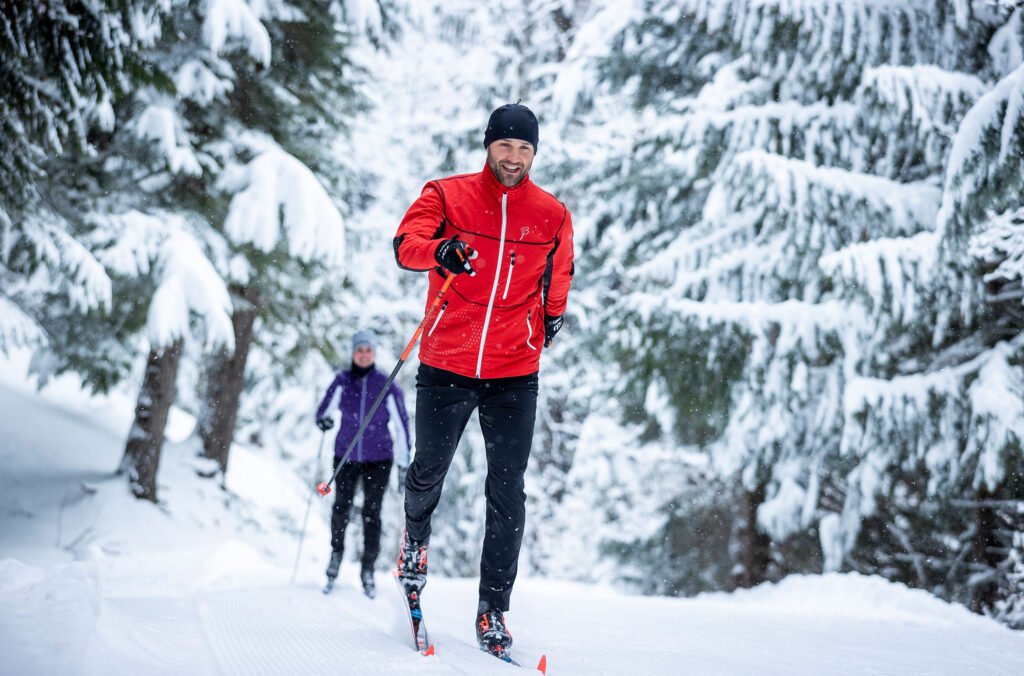 Two cross-country skiers enjoy the snowy trails around Lost Lake Park in Whistler.