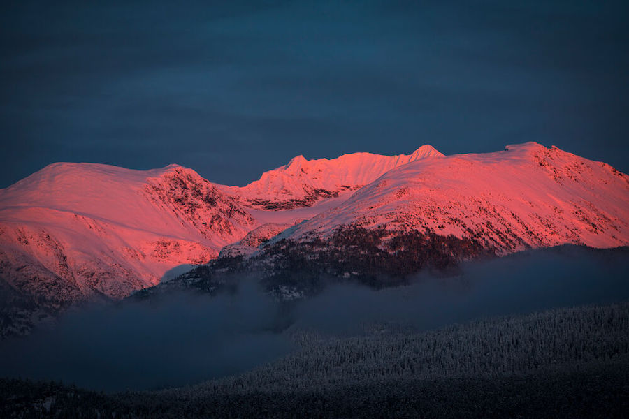 Alpenglow on snow-capped mountains.