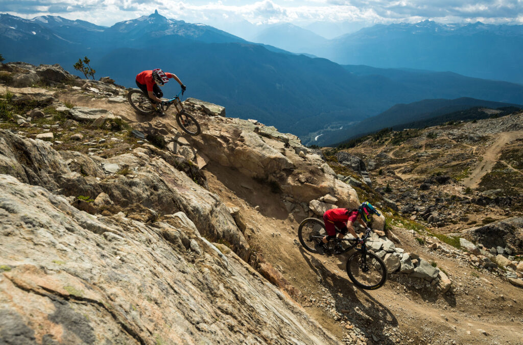 Two bikers make their way down Whistler Mountain in the bike park.