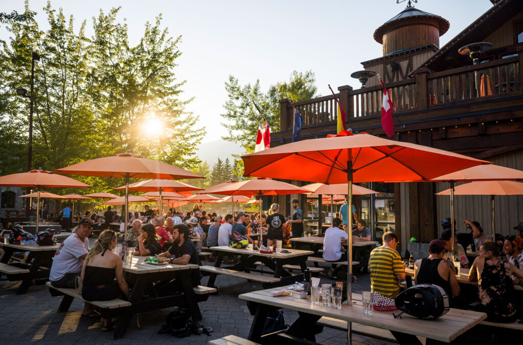 A shot of the bustling patio at Dusty's Bar & Grill located at the base of Whistler Mountain in Creekside Whistler.