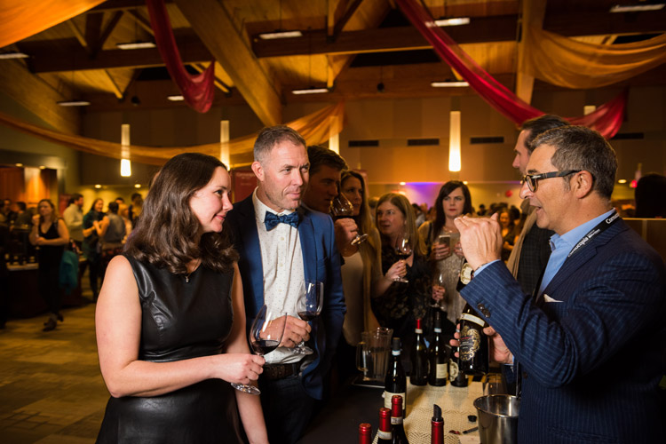 A couple sample wine at a table at the CRUSH event at Cornucopia. 