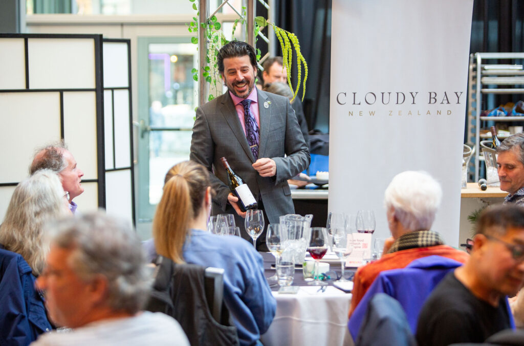 A winery representative talks about a certain varietal at a tasting event at Cornucopia.