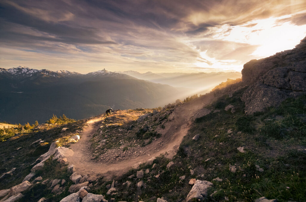 A mountain biker makes their way down the Top of the World trail on Whistler Mountain in the summer.