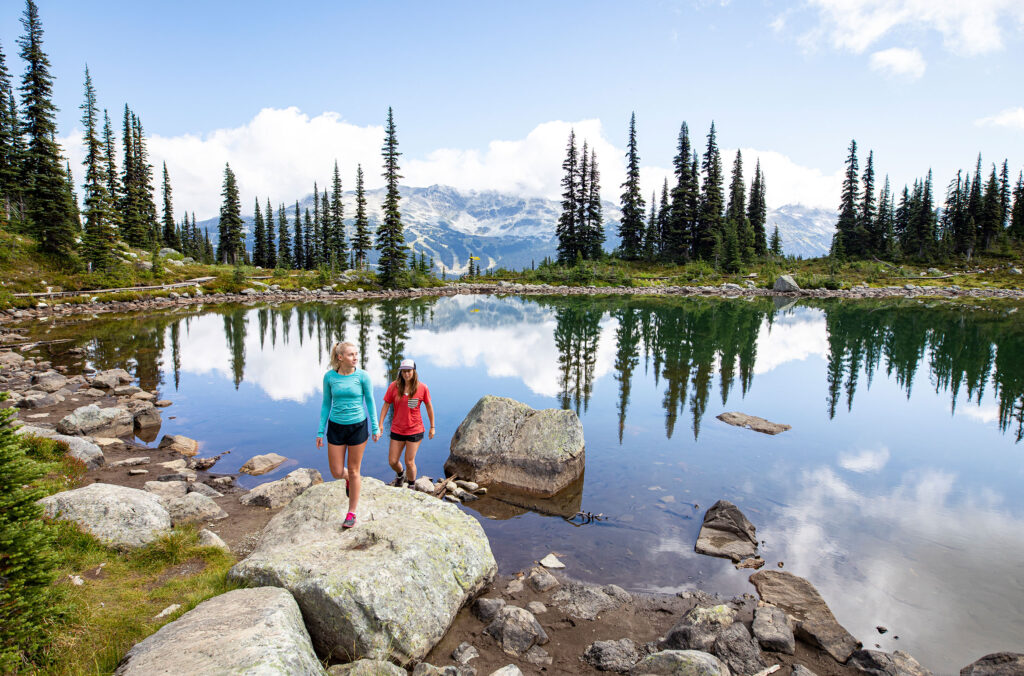 Two hikers explore the area around Harmony Lake on Whistler Mountain. 
