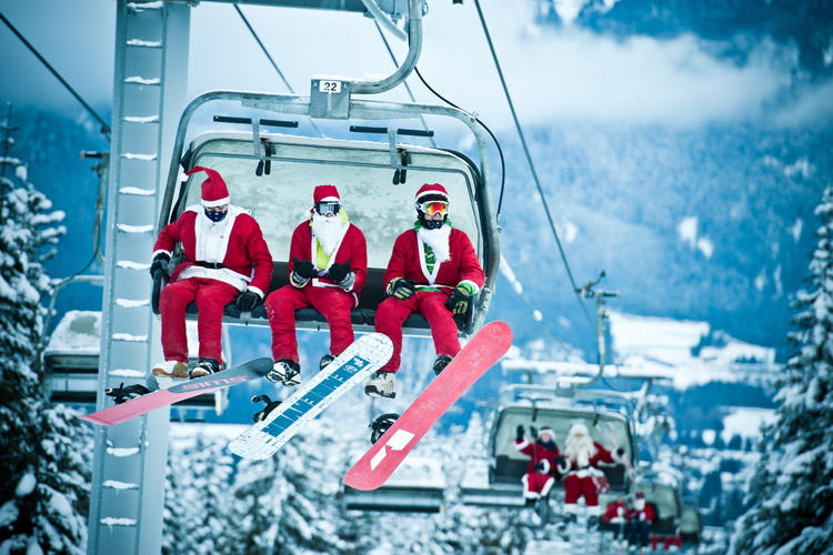 Skiers dressed as Santa on a chairlift in Whistler