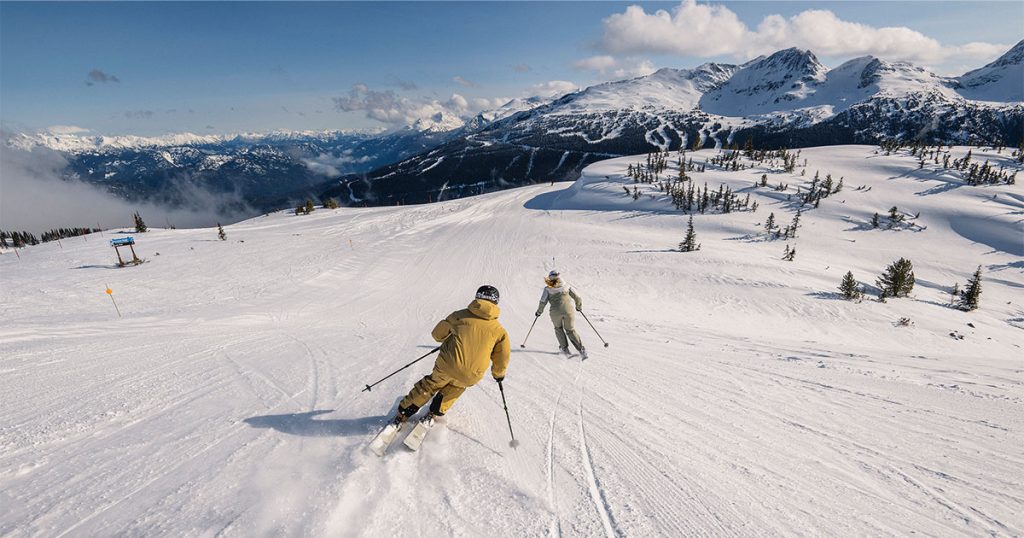 Two skiers enjoy the Harmony Ridge area on Whistler Blackcomb.