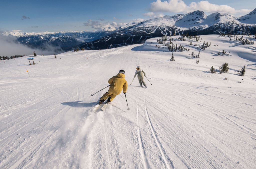 Two skiers enjoy the Harmony Ridge area on Whistler Blackcomb.