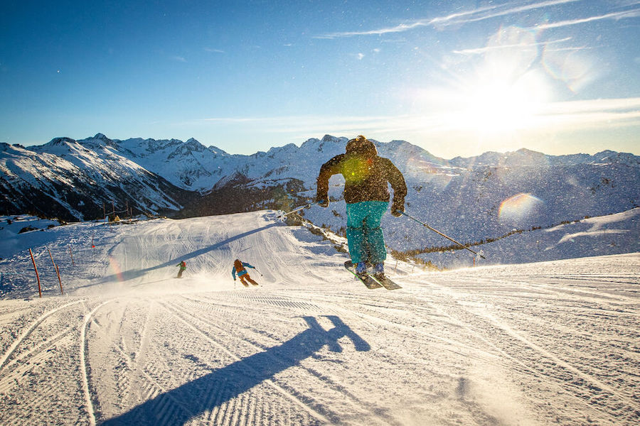 A skiier has a great time on a groomed run in Whistler.