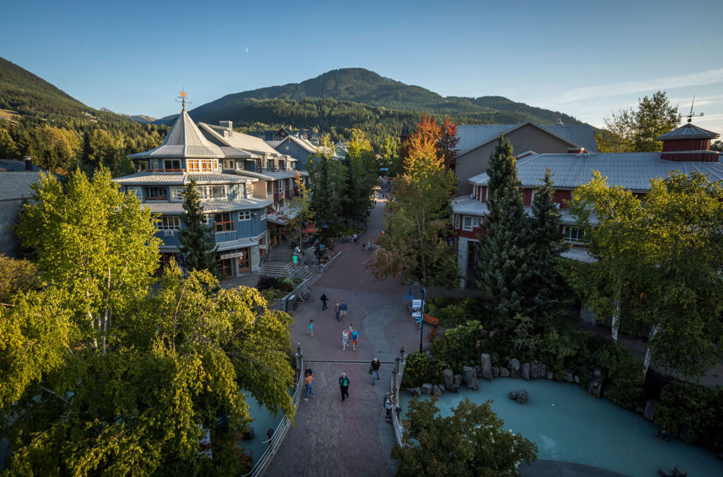 A shot of Whistler Village taken from above with the mountains in the background.