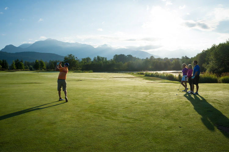 Golfer swings at Big Sky golf Course Pemberton