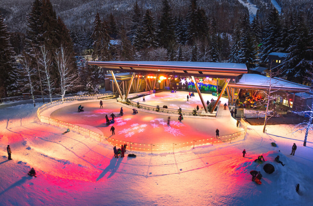 Whistler's outdoor ice skating rink in the winter, lights sparkling. 