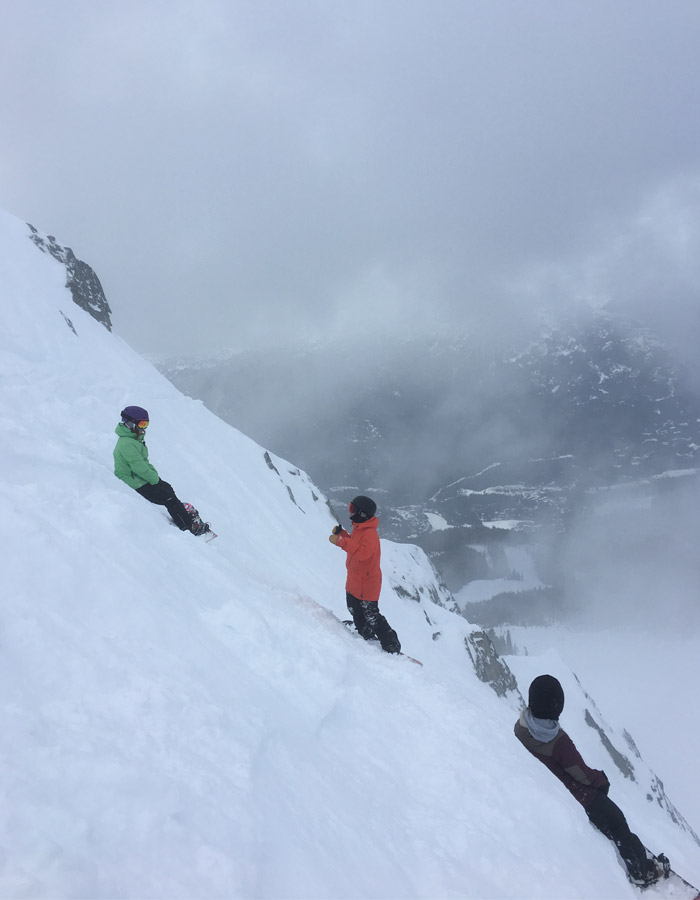 Women learn techniques to snowboard on Whistler's steep slopes