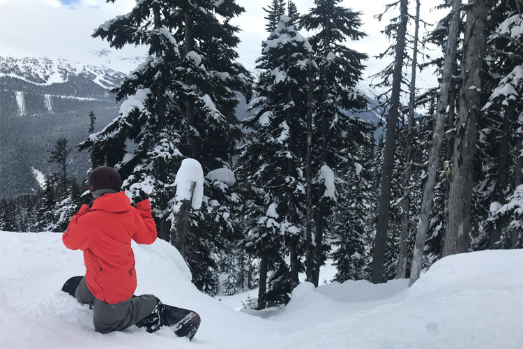 Women's snowboard instructor talks technique on tree runs