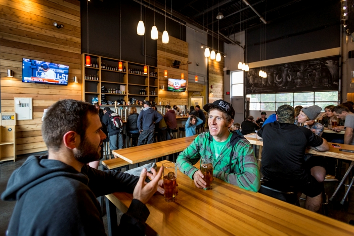 Two men drinking a beer at the brewery.