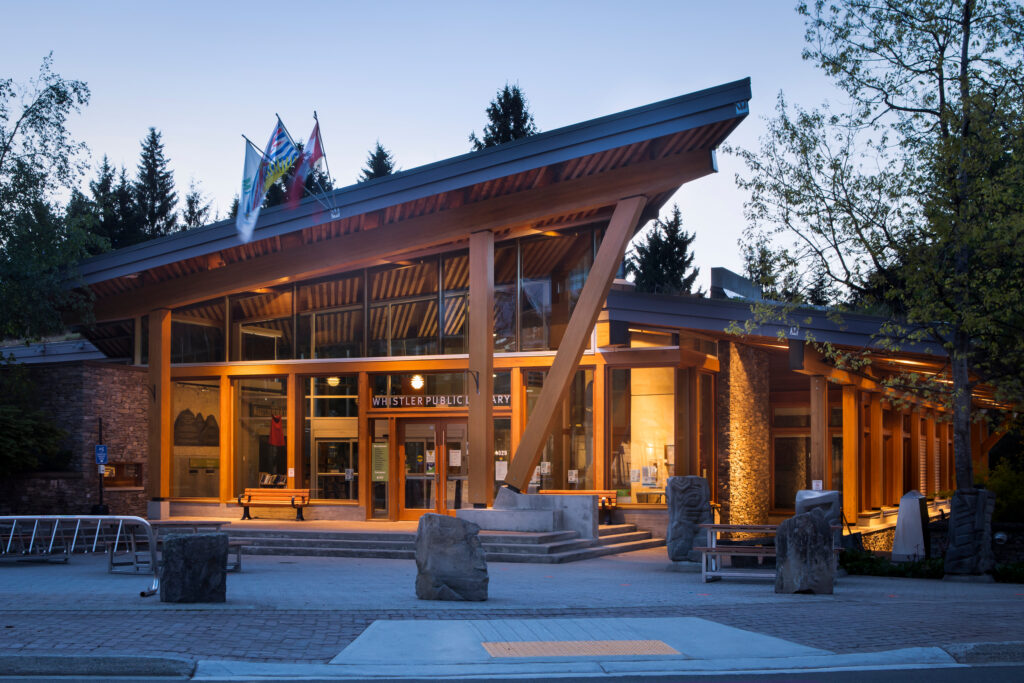 The Whistler Public Library lit up in the evening.