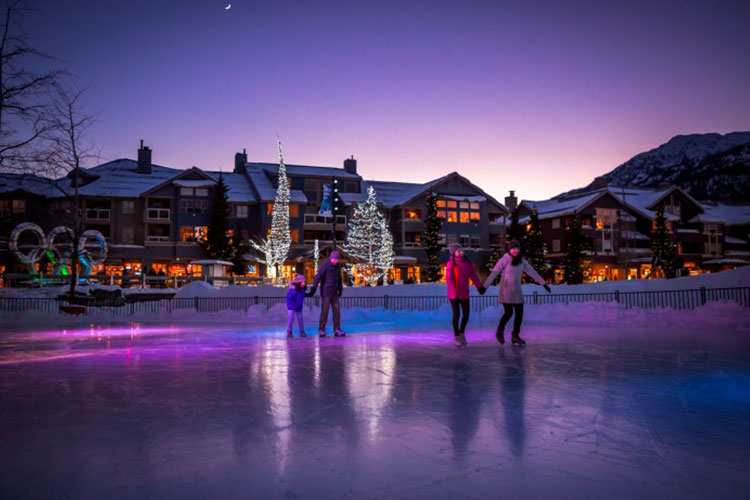 people skating at olympic plaza at dusk