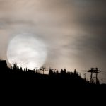 A full moon disappears behind the mountains in Whistler for Halloween.