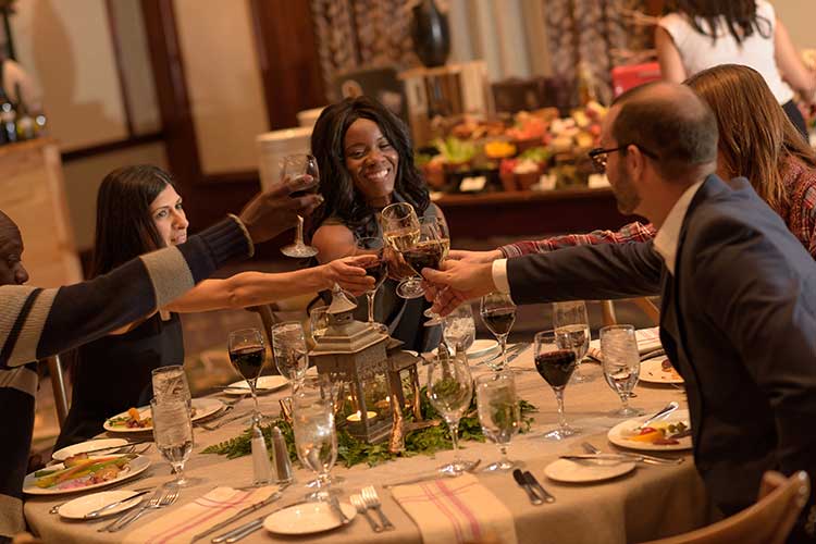 a group cheering around the dinner table