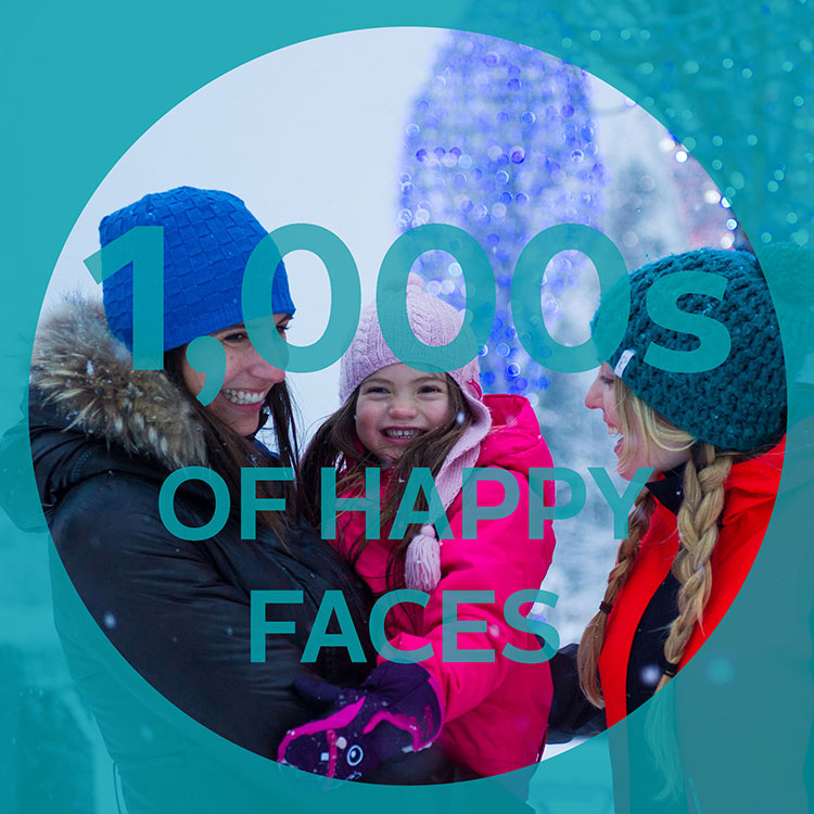 A family enjoy the festive lights in Whistler Village.