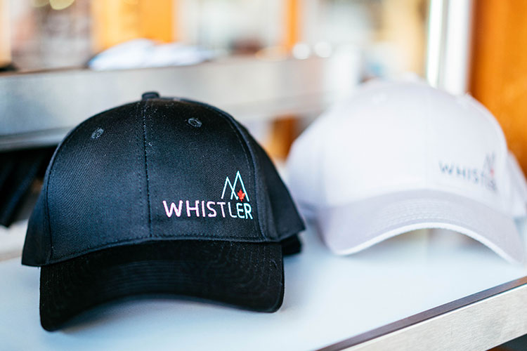 White and black Whistler branded caps.