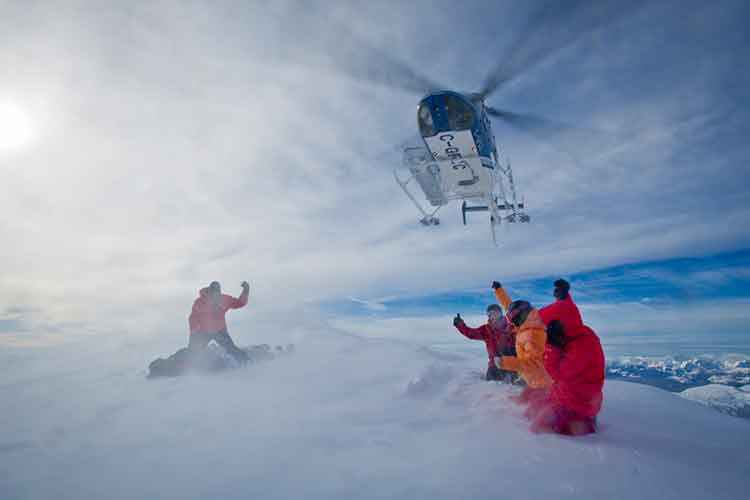 helicopter taking off after dropping off skiers