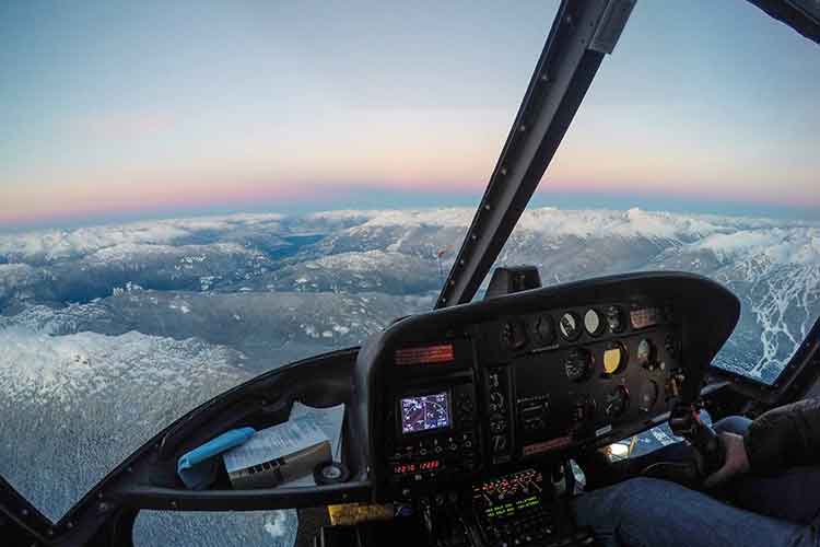 view out the front window of a helicopter at sunset