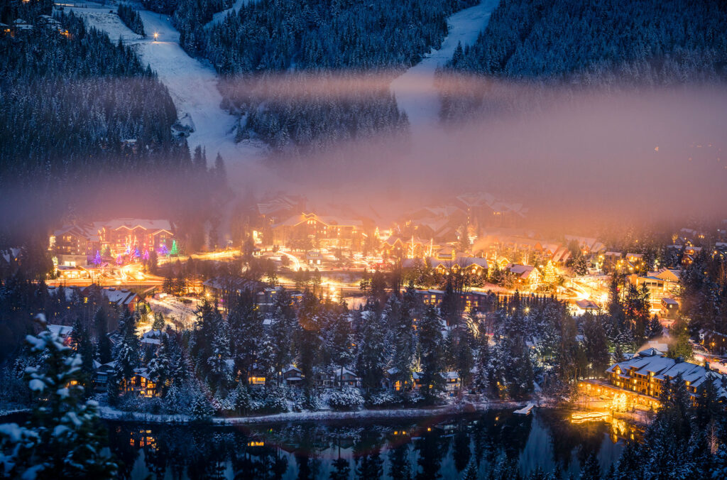 A shot of Creekside glowing at the base of Whistler Mountain in the winter.