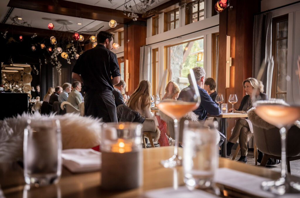 A shot of people dining at The Den at Nita Lake Lodge.