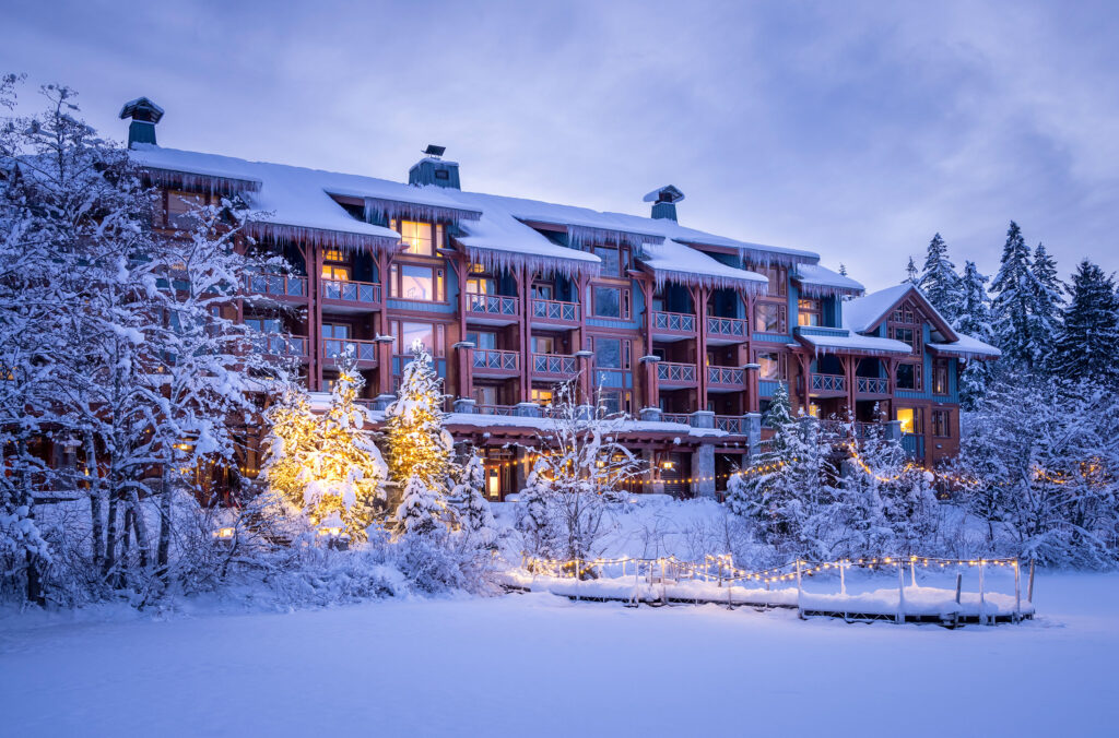 A wintery shot of the snow-clad Nita Lake Lodge as seen from the lake in Creekside.