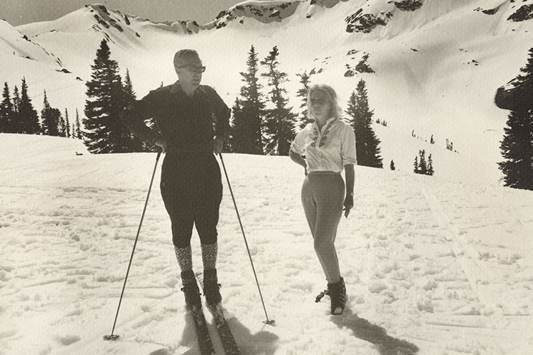 A black and white shot of a man and couple on the ski slopes in Whistler in 1960's attire..