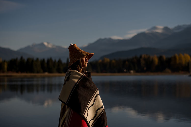 Redmond looks out over Alta Lake towards Whistler and Blackcomb Mountains.