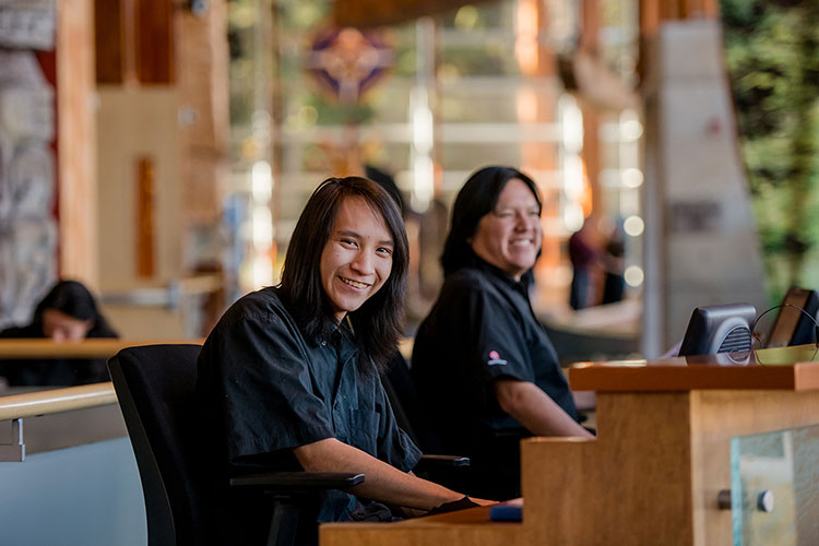 Redmond sits at the welcome desk of the SLCC.