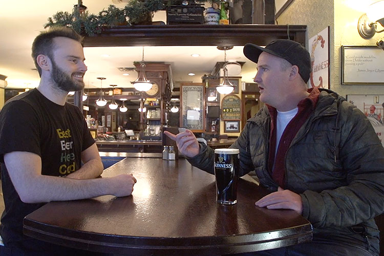 Brandon chats with a server at the Dubh Linn Gate about why he came to Whistler.