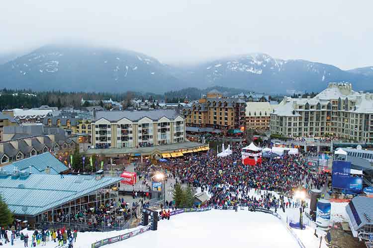 skiers plaza full of a waiting crowd for the Bir air competition.