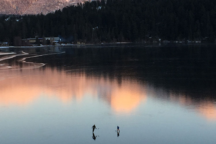 Two skaters on Green Lake in Whistler.