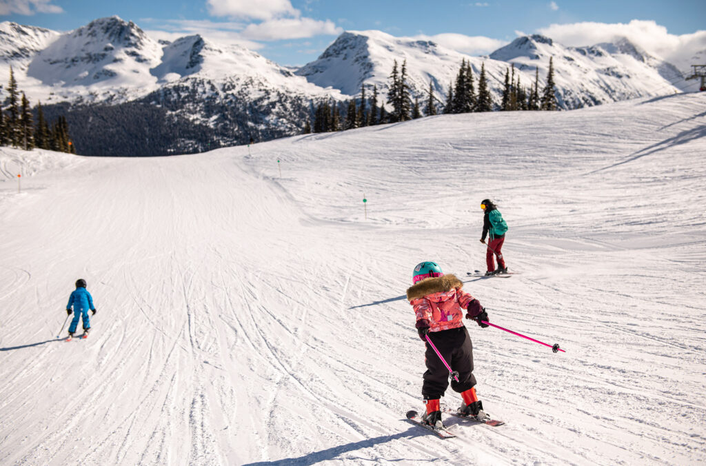A young family enjoy skiing the green runs on Whistler Blackcomb.