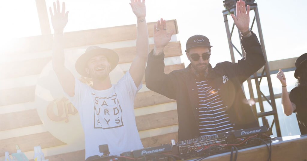 Two DJs play in the sunshine at the World Ski and Snowboard Festival in Whistler.