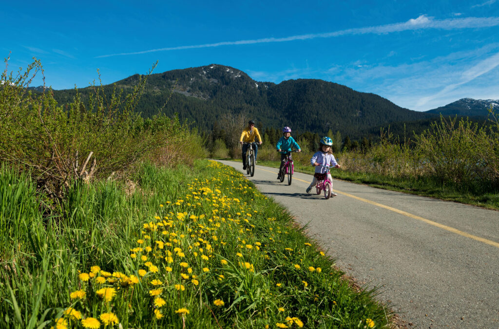 A family bikes along the Whistler Valley Trail.