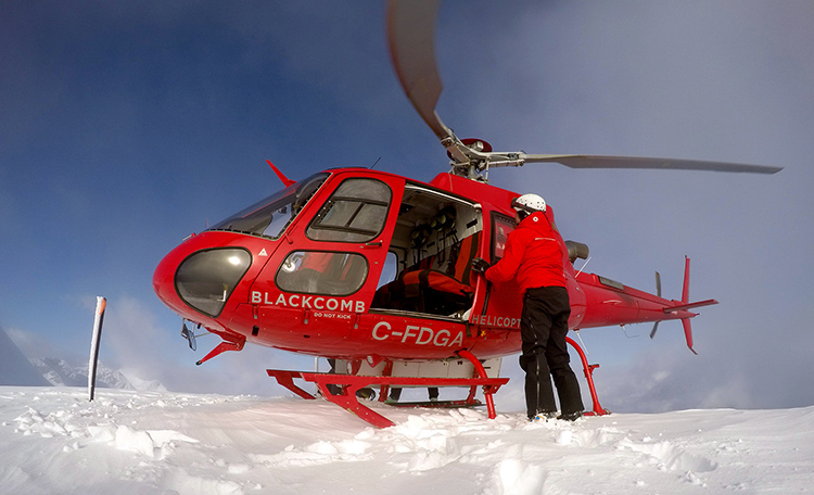 Helicopter dropping off skiers in Whistler