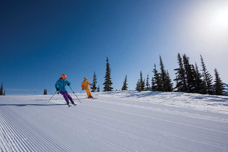 couple skiing on beautiful sunny day