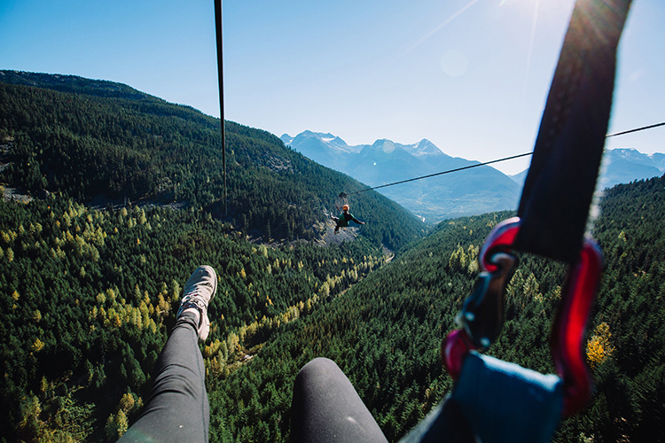 Ziplining by a mountain view in Whistler