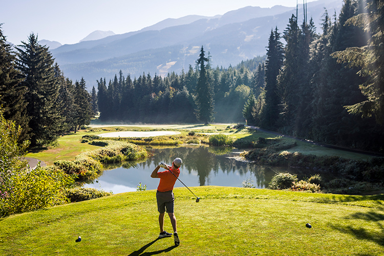 Golfer taking a swing at the Whistler Golf Club