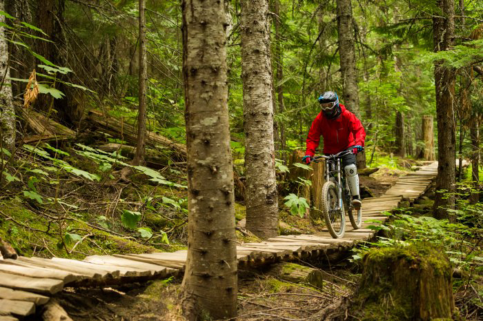 Rider in appropriate mountain biking safety gear